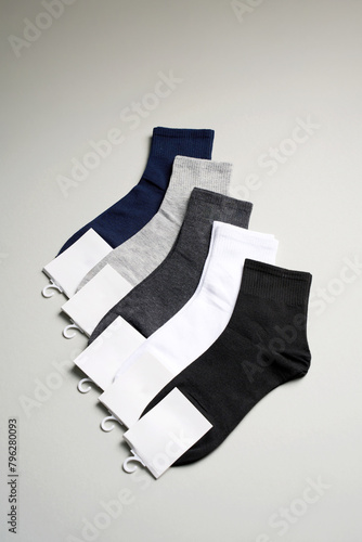 Mens new socks on a gray background, close-up. Cotton socks with blank label