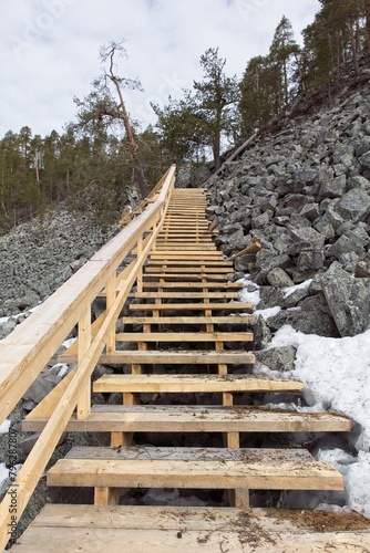 Wooden steps at Aittakuru gorge in cloudy spring weather with snow on the ground, Pelkosenniemi, Lapland, Finland. photo