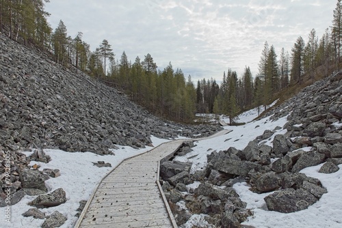 Broadwalk at Aittakuru gorge in cloudy spring weather with snow on the ground, Pelkosenniemi, Lapland, Finland. photo