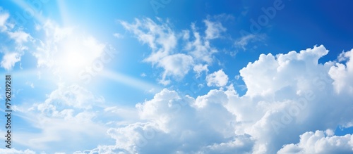 Sun shining through a large fluffy cloud photo