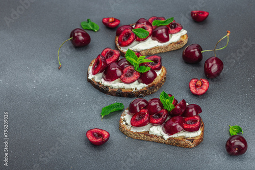 Fresh bread sandwiches with sweet cherry, cream cheese and mint leaves. Morning breakfast concept © FuzullHanum
