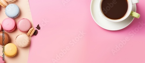 coffee cup and macarons on a pink backdrop photo