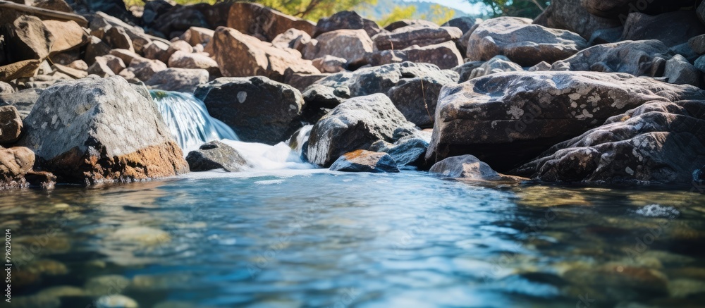 Fototapeta premium Water cascades over smooth rocks in stream