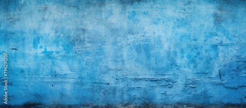 Blue wall grunge texture with concrete floor photo