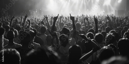 A black and white photo of a crowded concert venue. Suitable for music events promotion