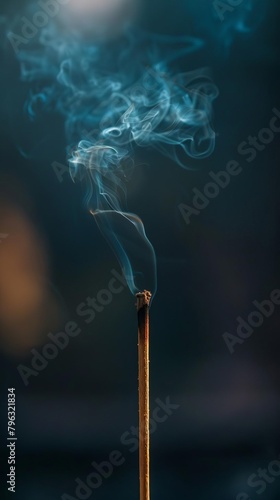 An incense stick burning in the dark photo