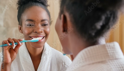 Close up of a young women in a white bath towel brushing her teeth