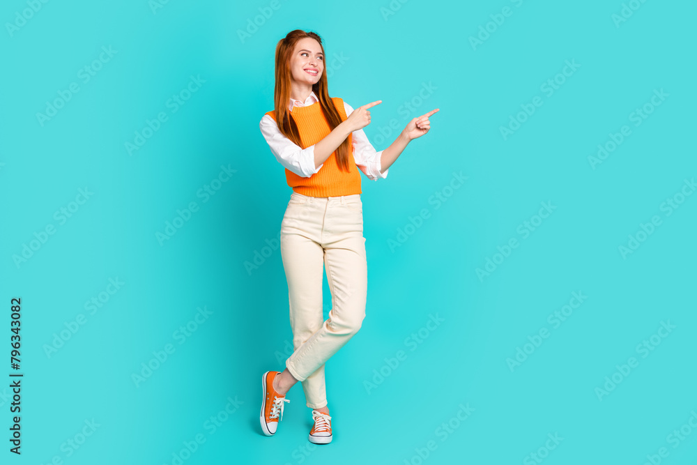 Full length photo of lovely cute girl wear trendy clothes look banner empty space isolated on aquamarine color background Full length photo of lovely cute girl wear trendy clothes look banner empty space isolated on aquamarine color background