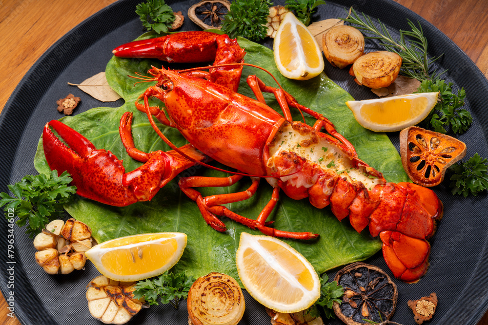 Grilled Lobster with Cheese in black wood plate, Grilled Canadian Lobster on wooden background. Grilled Lobster with Cheese in black wood plate, Grilled Canadian Lobster on wooden background.