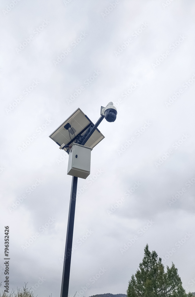 Security camera with solar panel on a pole outdoors. Security camera with solar panel on a pole outdoors.