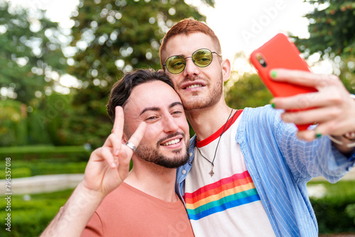 Sunshine brightens the selfie of an exuberant LGBT couple.
