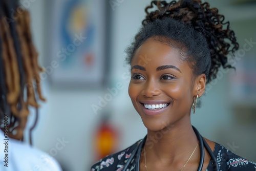 A cheerful woman with beautiful curly hair smiling warmly during an engaging conversation, set against a blurred background