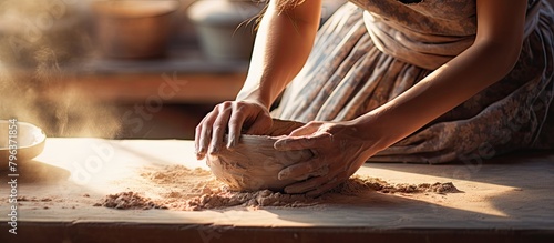 Woman shaping pottery on table
