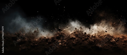 Dusty soil pile swirls particles photo