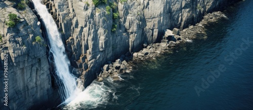 Waterfall Cascading Down Cliff into River