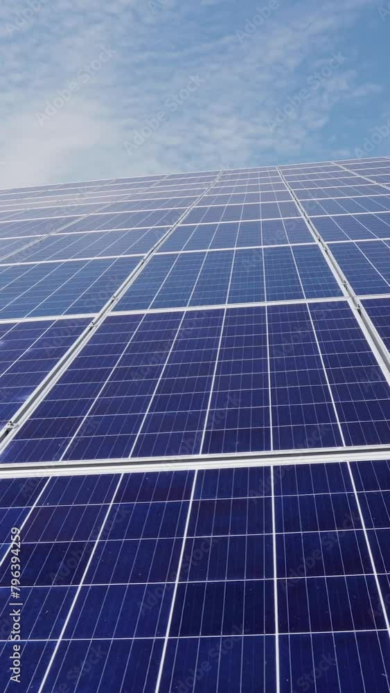 Solar panels against blue sky and clouds Alternative energy. Vertical video. Solar panels against blue sky and clouds Alternative energy. Vertical video.
