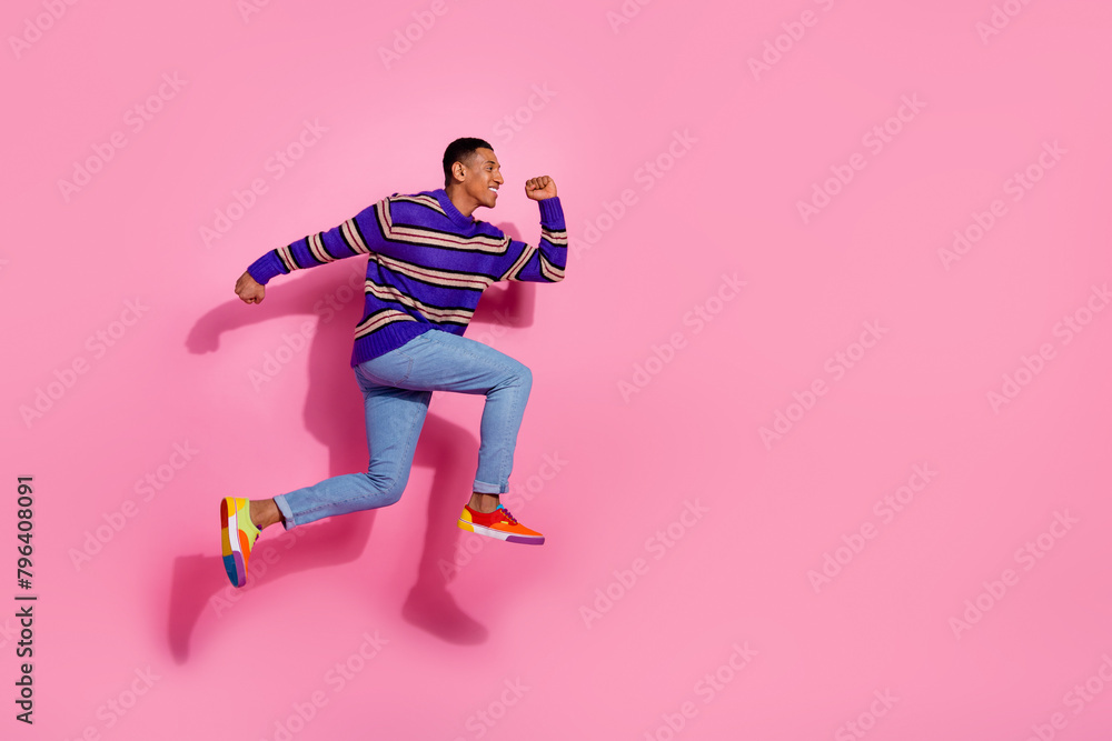 Full size photo of pretty young male excited running hurry sales dressed stylish violet striped outfit isolated on pink color background