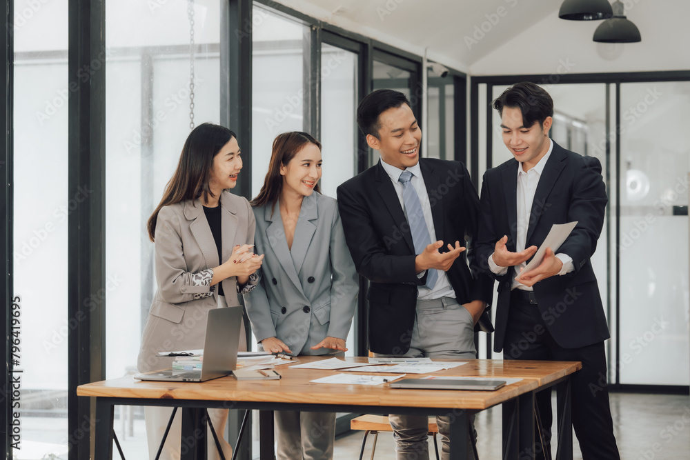 Young motivated Asian business team discussing oh business strategy in the modern meeting room. Young motivated Asian business team discussing oh business strategy in the modern meeting room.