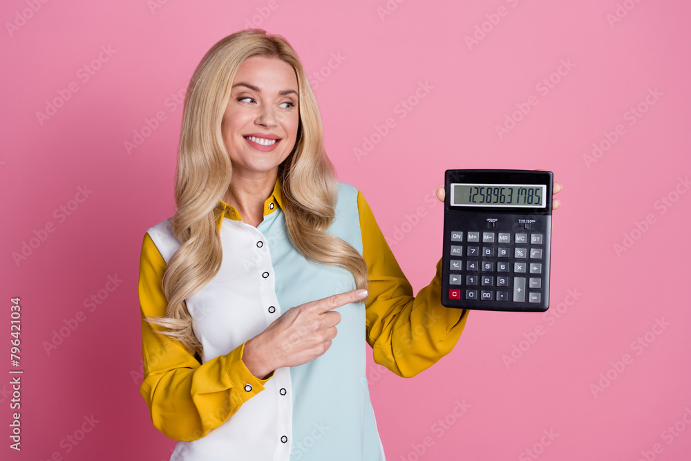 Photo of charming pretty woman banker showing nubmers money income isolated on pink color background Photo of charming pretty woman banker showing nubmers money income isolated on pink color background