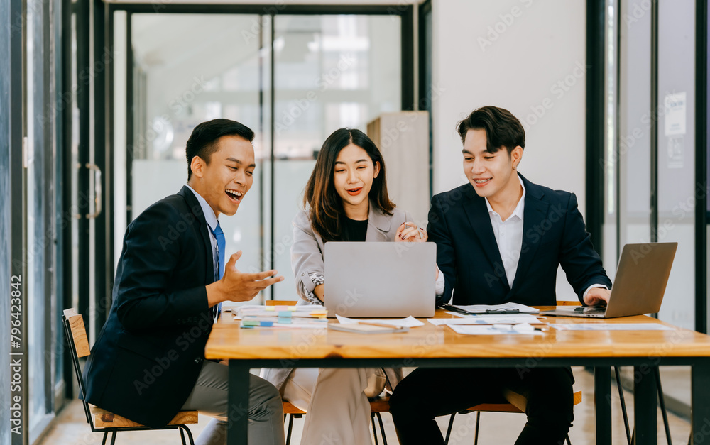 Meeting of Asian business people who are committed to work. Creative business teams work together in the office, discussing issues that need to be resolved, and
