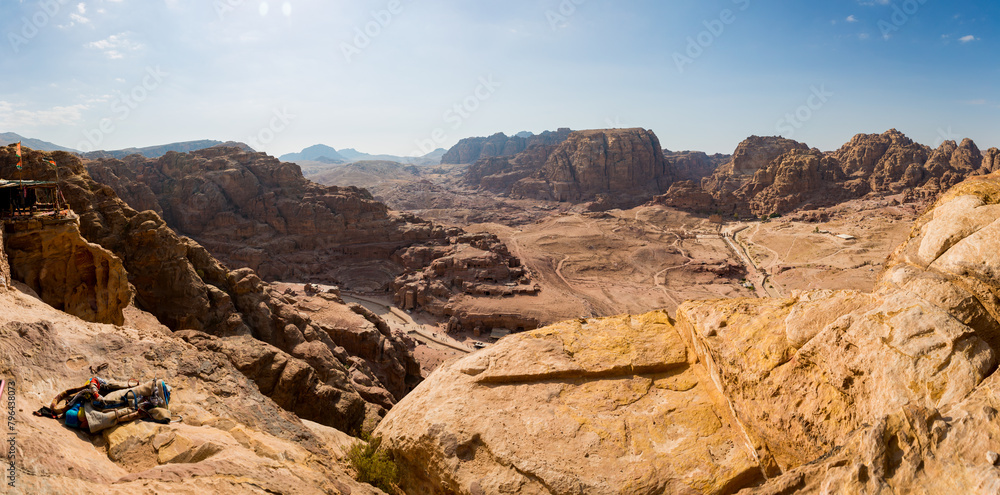 A view from above of the valley of the archeological site of Petra in Jordan with a view of the Nabatean Theatre and Qasr al-Bint