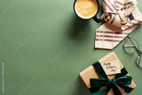 Happy Fathers Day concept. Flat lay composition with gift box, necktie, glasses, coffee cup on green background.