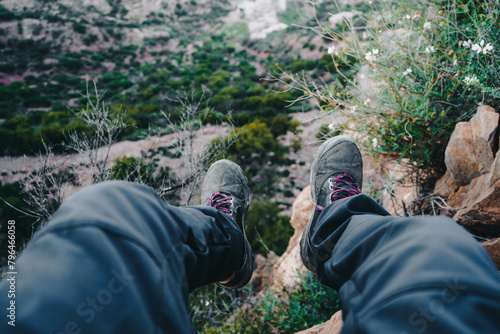 Wallpaper Mural person's legs and feet on a rock surrounded by mountainous terrain and plants.
 Torontodigital.ca