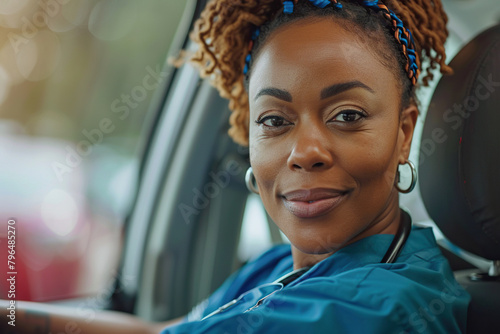 Female nurse sitting in car, going home from work. Female African American doctor driving car to work, on-call duty. Work-life balance of healthcare worker. photo