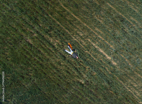Aerial view of a burning man laying in a field. Burnout concept.