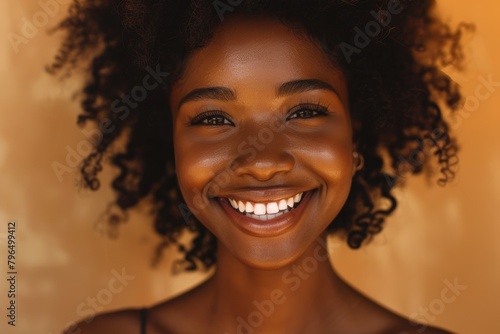 Black woman's face, teeth, and beauty with eyes closed in orange studio. Skincare, cosmetics, and natural makeup of cheerful female model laughing, smiling, and carefree.