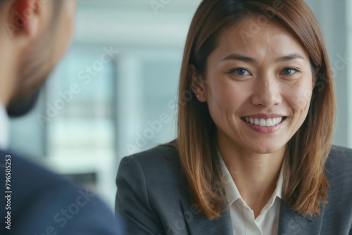 Free Download Face of smiling Asian businesswoman she discusses project with colleague in modern office, corporate interview - GFXLoad
