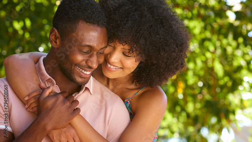 Close Up Portrait Of Loving Multi-Racial Couple Or Friends Hugging Outdoors  In Countryside Together