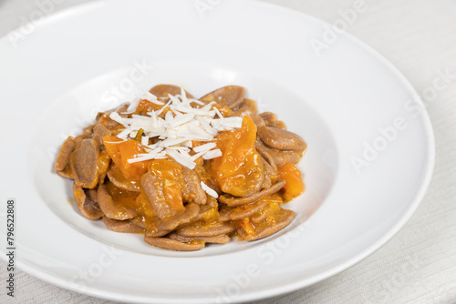 Strascinate with burnt wheat, a typical Apulian dish. Strascinate di grano arso, yellow cherry tomatoes and cacioricotta.