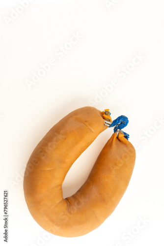 A farinheira is a Portuguese sausage made of pork fat, flour, paprika, and garlic. This stock photo shows a single farinheira on a white background, emphasizing its distinct color and texture. photo