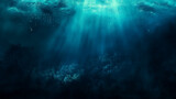 This is an image of the ocean floor. The water is dark blue and there are some bright spots, which are probably sunlight shining through the water. There are also some dark shapes, which are probably 