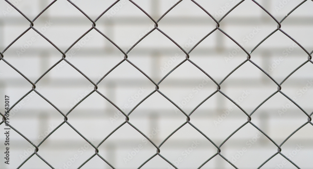 metal mesh and a brick wall behind it metal mesh and a brick wall behind it