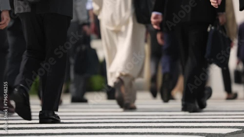 横断歩道を渡り朝の通勤するビジネスマンたちの後ろ姿の足元　東京 photo