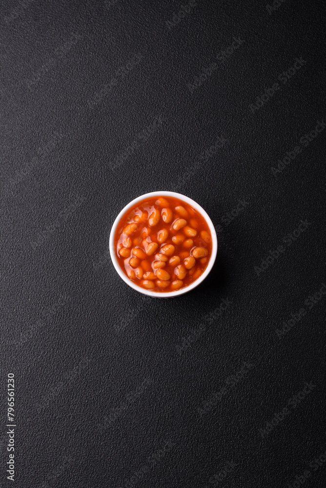 Delicious nutritious canned beans in tomato, with salt and spices Delicious nutritious canned beans in tomato, with salt and spices