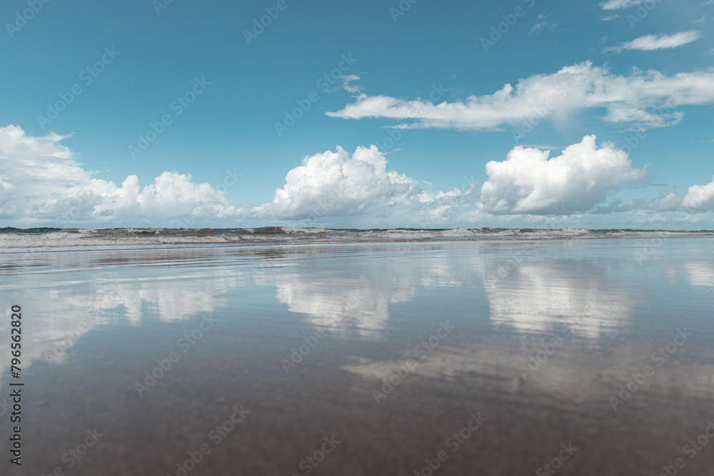 View of a tropical beach with clouds on the horizon in Porto de Galinhas, Brazil.