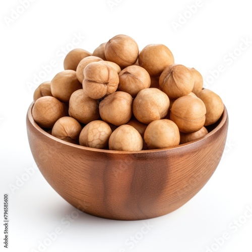 Macadamia in a wooden bowl isolated on white background, macadamia nuts, Shelled Macadamia nuts
