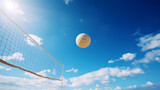 Volleyball flies over beach volleyball under blue sky and sunshine
