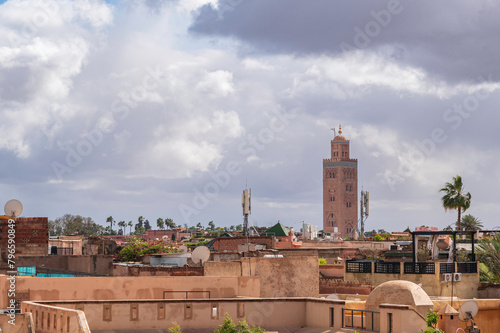 View of rooftops of Marrakech close to the city centre. Koutoubia Mosque minaret during a rare cloudy day. © parkerspics