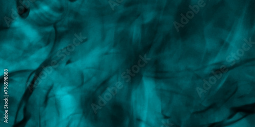 blue smoke abstract background. Mystical swirling smoke rolling low across the ground. Abstract background of chaotically mixing puffs of smoke on a dark background. Selective focus. Toned.