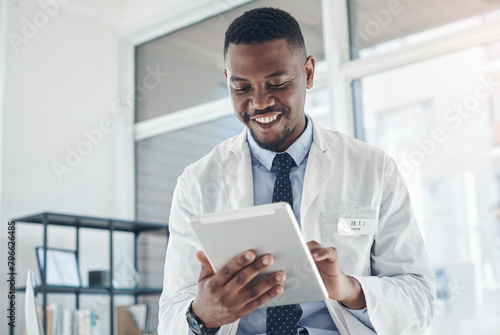 Doctor, black man and happy with tablet online results of electronic health records, improved patient wellness and reading. Medical worker, digital technology and proud for progress and telehealth.
