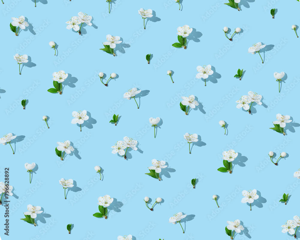 Seamless cherry blossom pattern on light blue background Seamless cherry blossom pattern on light blue background