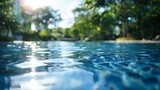 The hustle and bustle of the city fades into a blur as the focus shifts to a sparkling pool surrounded by trees and the sky creating a peaceful oasis in the midst of the urban chaos. .