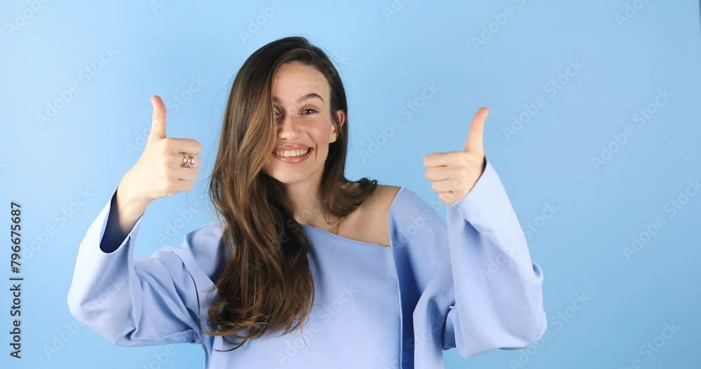 Young woman making good-bad sign isolated on blue background. Girl make choice, or makes a decision thumb up or thumb down, like or dislike, yes or no. Woman change emotions, raised hands. Young woman making good-bad sign isolated on blue background. Girl make choice, or makes a decision thumb up or thumb down, like or dislike, yes or no. Woman change emotions, raised hands.