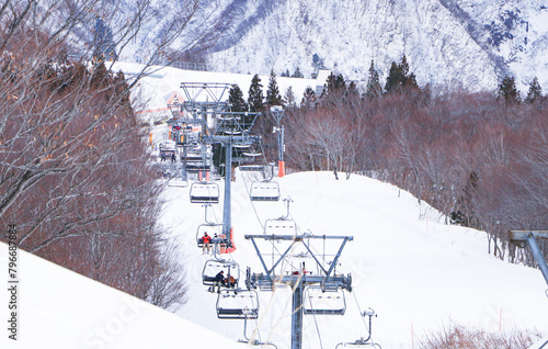 Lift or ropeway skiing snow. Empty chairlift on background of snowy slopes. Winter landscape tree of ski resort. Winter sports during vacation. scenic cable car flying over piste snow covered mountain