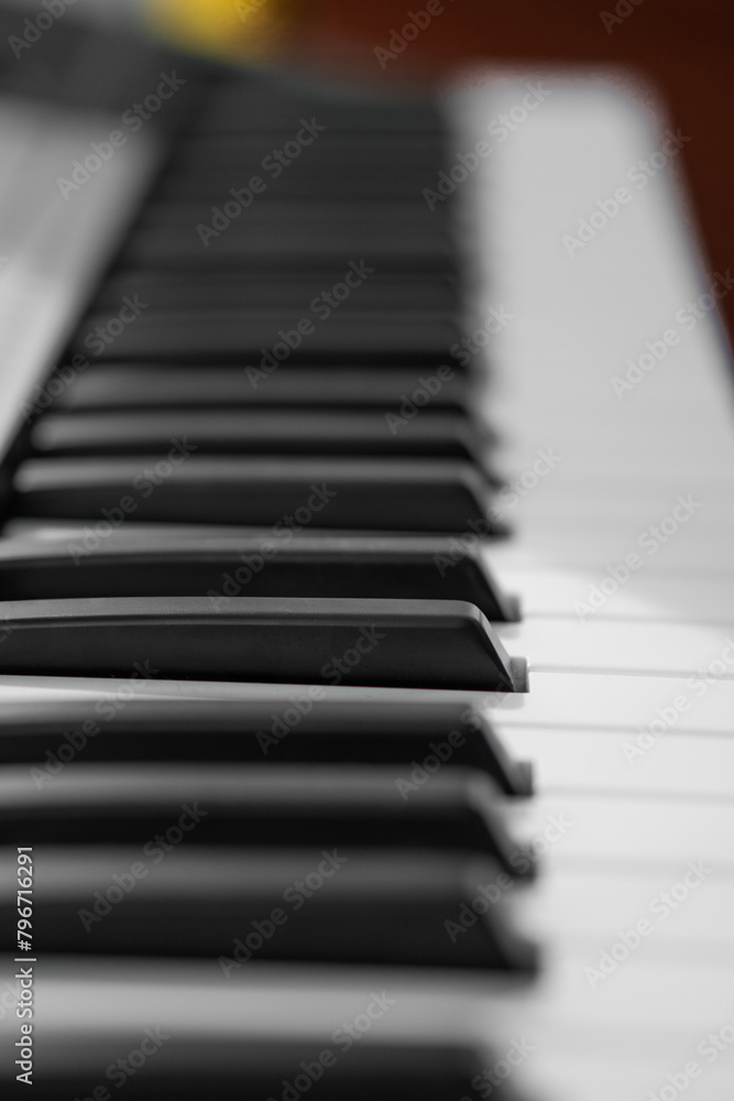 piano keys, blurred background in the distance piano keys, blurred background in the distance
