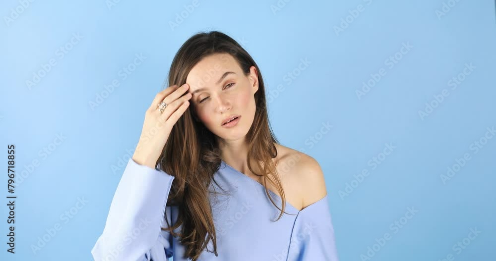 Facepalm, sorrow emotions. Upset worried brunette woman slapping hand on face and expressing regret, blaming herself for troubles, feeling helpless isolated on blue background. Facepalm, sorrow emotions. Upset worried brunette woman slapping hand on face and expressing regret, blaming herself for troubles, feeling helpless isolated on blue background.